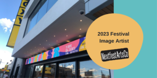 A big sign in front of the Roxy theatre displays the 2022 Festival image.